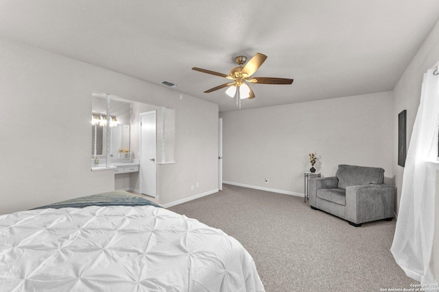 carpeted bedroom with a ceiling fan, visible vents, connected bathroom, and baseboards