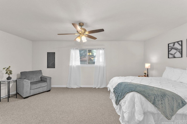 bedroom with light colored carpet, ceiling fan, and baseboards