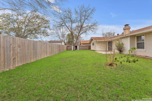 view of yard with a fenced backyard