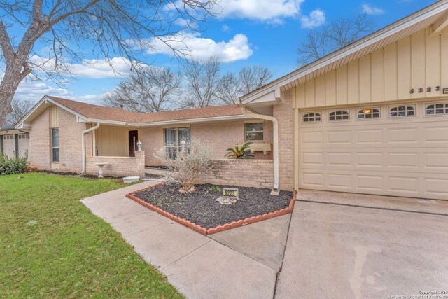 ranch-style home with a garage, brick siding, concrete driveway, roof with shingles, and a front lawn