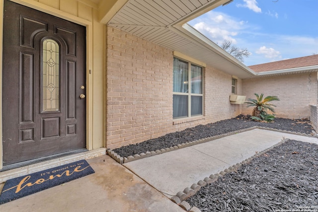 property entrance with brick siding