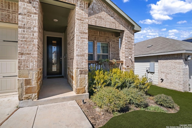 doorway to property featuring brick siding