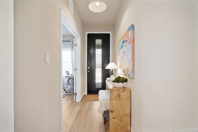 hall with visible vents and light wood-style flooring