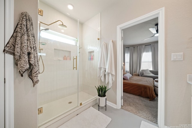 ensuite bathroom featuring ensuite bathroom, a shower stall, and baseboards