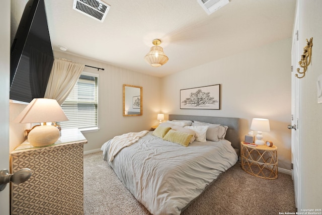 carpeted bedroom featuring baseboards and visible vents