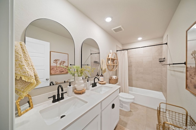 bathroom featuring toilet, a sink, visible vents, and shower / bathtub combination with curtain