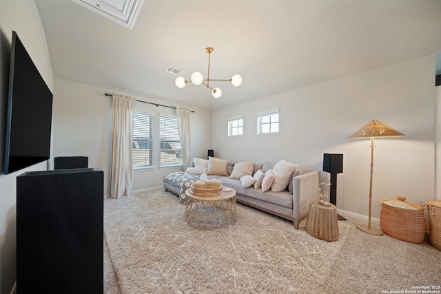 living room with carpet flooring, visible vents, baseboards, and an inviting chandelier