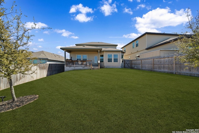 back of property featuring a fenced backyard and a yard