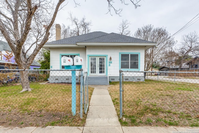 bungalow with a fenced front yard, a shingled roof, french doors, a chimney, and a front yard