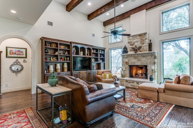 living room with a healthy amount of sunlight, dark wood-style floors, and visible vents