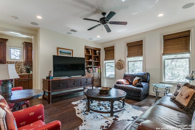 living room featuring visible vents, dark wood finished floors, ceiling fan, built in shelves, and recessed lighting