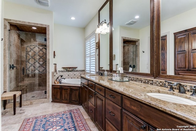 bathroom featuring a stall shower, visible vents, and a sink