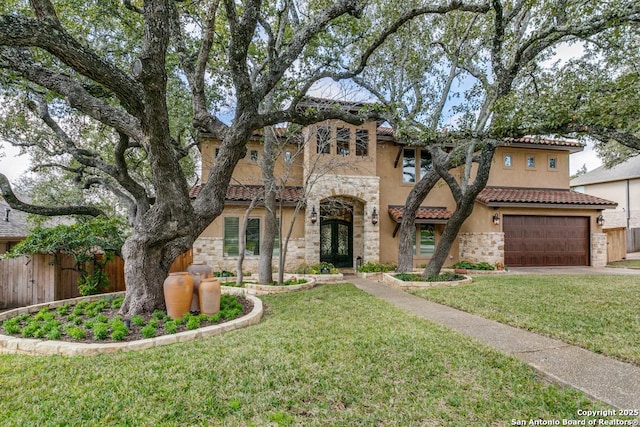 view of front of home featuring a front yard, stone siding, fence, and stucco siding