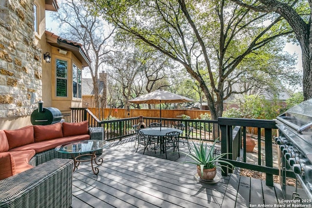 deck featuring outdoor dining space, outdoor lounge area, and a fenced backyard