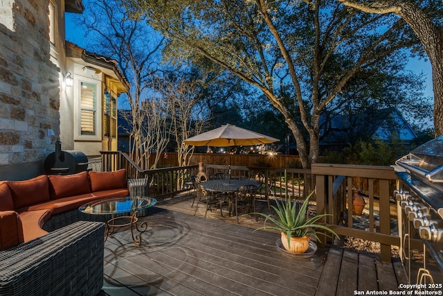 deck with outdoor dining area, outdoor lounge area, and fence