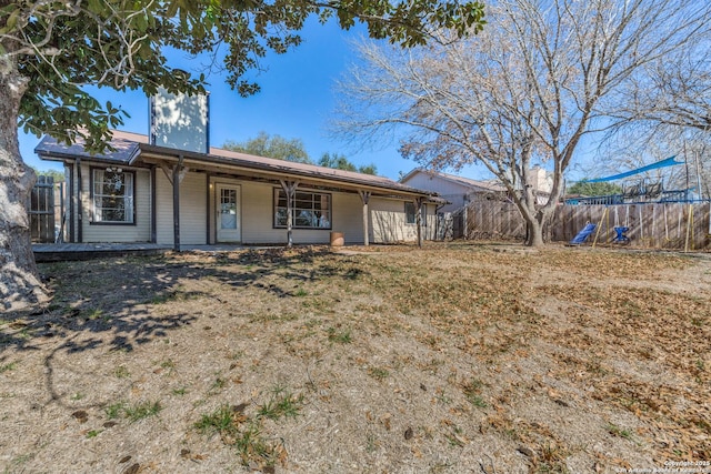 view of front facade with a porch and fence