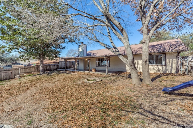 rear view of property featuring fence private yard, a patio area, and a chimney