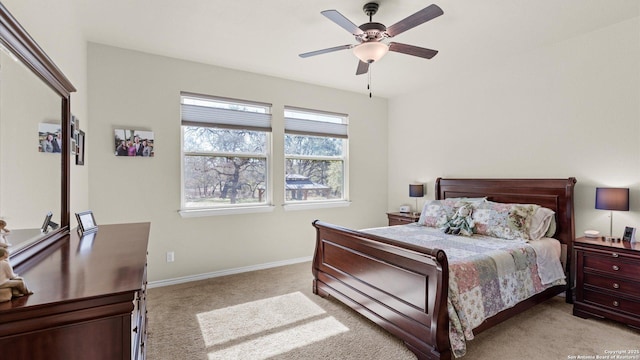 bedroom with baseboards, a ceiling fan, and light colored carpet