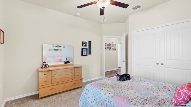 bedroom featuring light carpet, a closet, visible vents, and baseboards