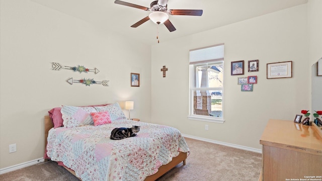 carpeted bedroom with ceiling fan and baseboards