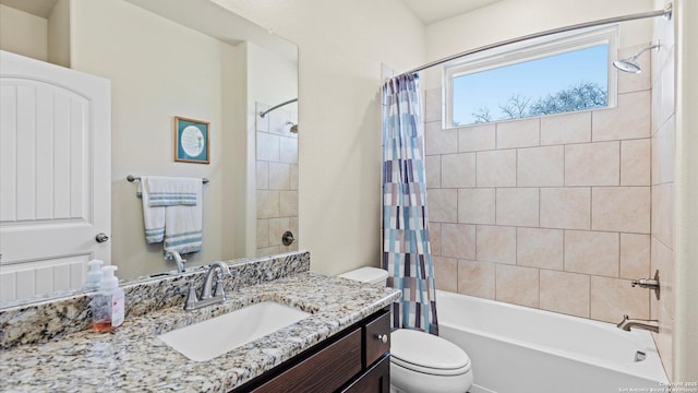 full bathroom featuring shower / bath combo, vanity, and toilet