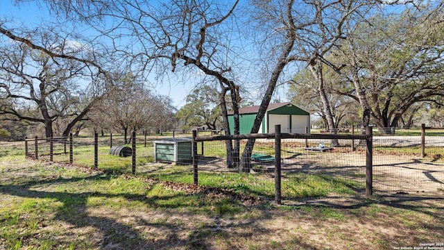 view of yard featuring a garage and fence