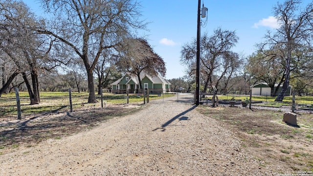 view of road with driveway, a gated entry, and a gate