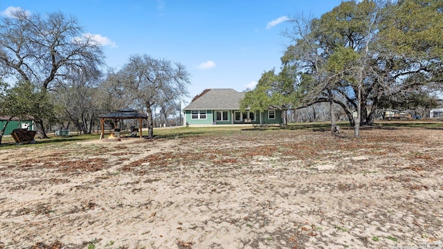 back of house with a gazebo