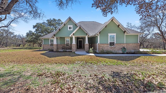 craftsman-style home featuring brick siding