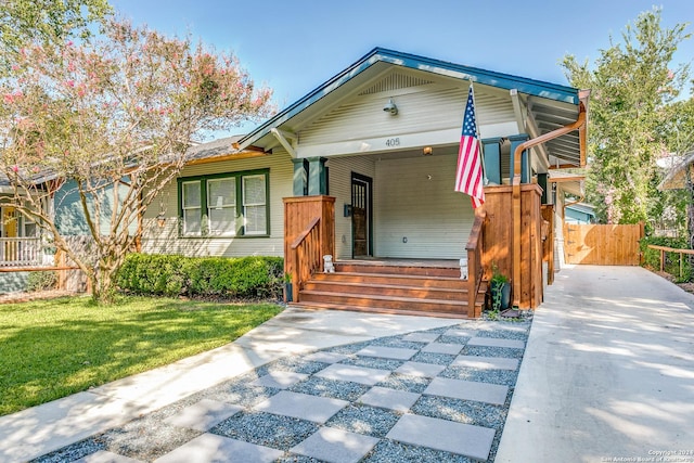 bungalow with fence and a front yard