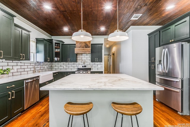 kitchen featuring glass insert cabinets, wood ceiling, pendant lighting, and stainless steel appliances