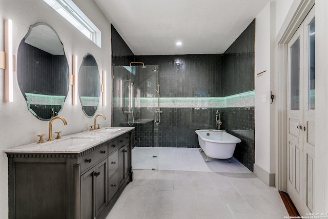 bathroom featuring double vanity, a freestanding tub, a sink, and a shower stall