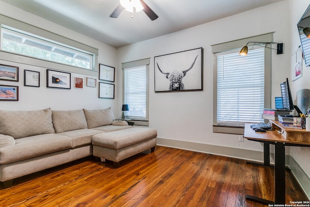 living room with plenty of natural light, ceiling fan, baseboards, and dark wood finished floors