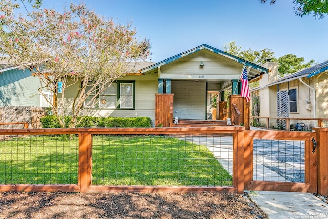 view of front facade with a fenced front yard, a front yard, and a gate