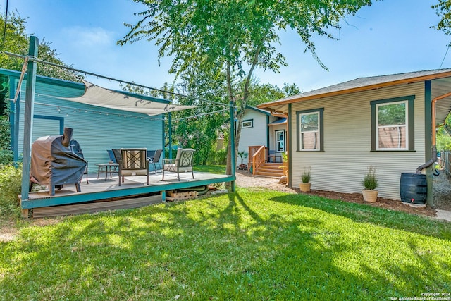 rear view of property featuring a yard and a wooden deck