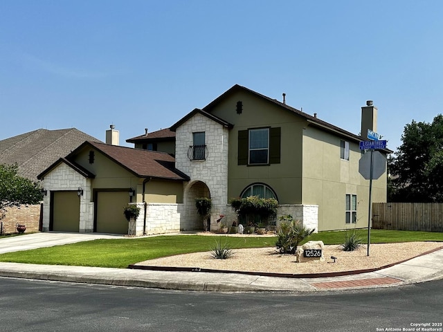 view of front of property with an attached garage, driveway, fence, and a front lawn