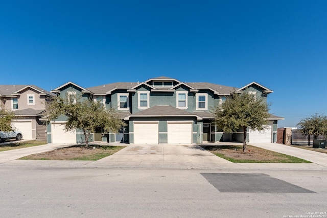 view of front of property featuring driveway, a garage, and a residential view