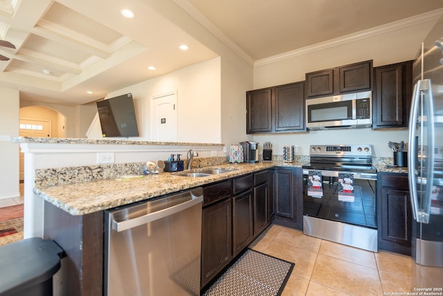 kitchen featuring a peninsula, a sink, ornamental molding, appliances with stainless steel finishes, and light stone countertops