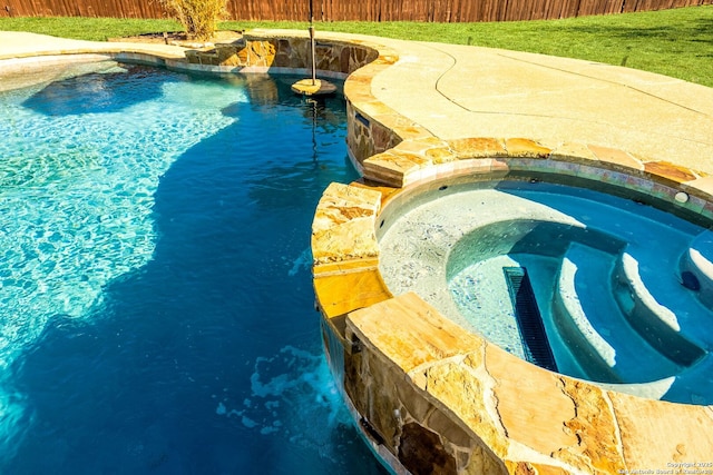 view of pool featuring an in ground hot tub, fence, and a fenced in pool