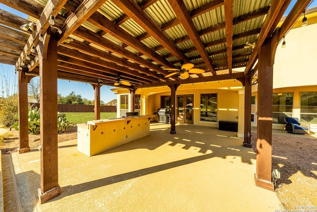 view of patio featuring ceiling fan and fence