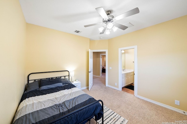 bedroom featuring light colored carpet, visible vents, a ceiling fan, a sink, and baseboards