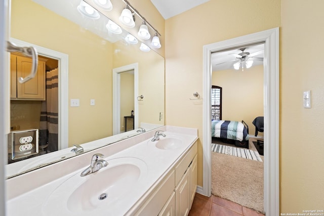 full bath with double vanity, ensuite bathroom, a sink, and tile patterned floors