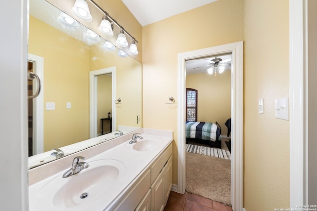 full bathroom with double vanity, tile patterned flooring, a ceiling fan, and a sink