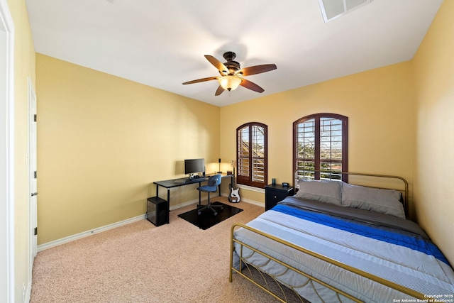 carpeted bedroom with baseboards, visible vents, and a ceiling fan