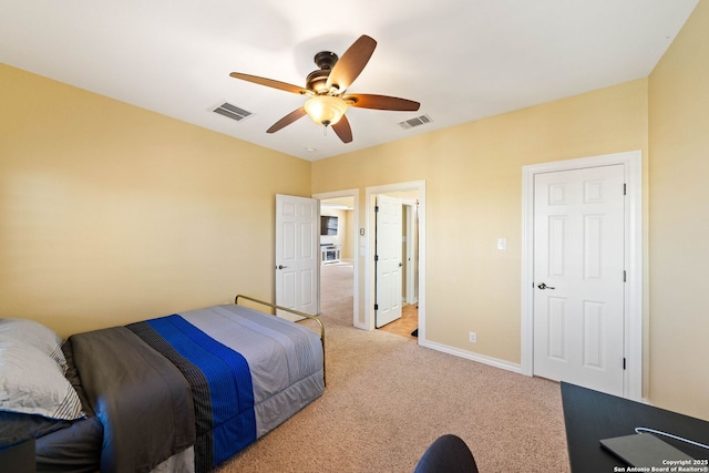 bedroom featuring light carpet, baseboards, visible vents, and a ceiling fan