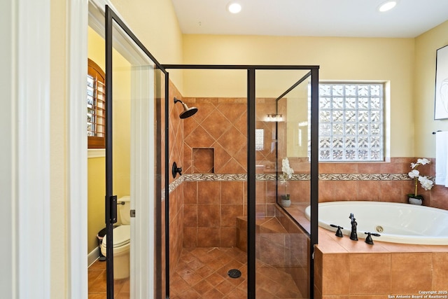 bathroom with tile patterned flooring, a garden tub, a shower stall, and toilet