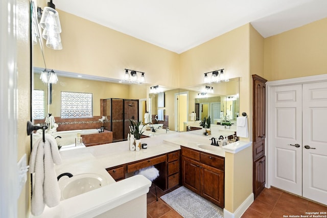 full bathroom featuring double vanity, walk in shower, a sink, and tile patterned floors