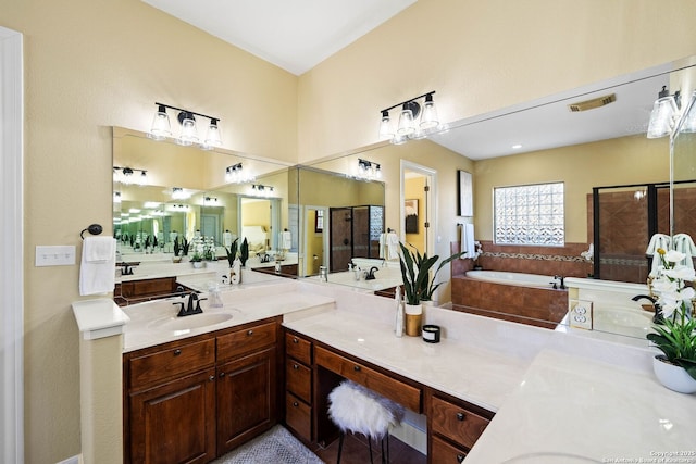 bathroom featuring a stall shower, visible vents, a garden tub, and vanity