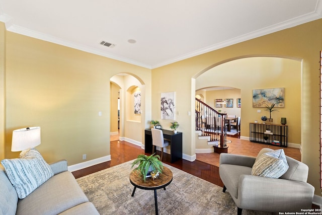 living room with arched walkways, stairs, visible vents, and baseboards