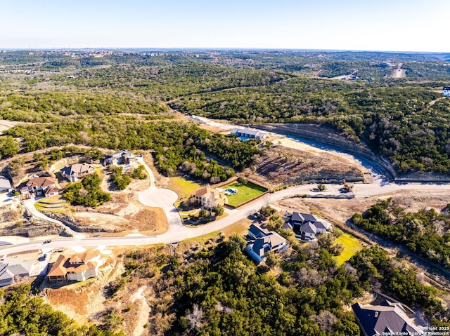 birds eye view of property featuring a residential view and a wooded view